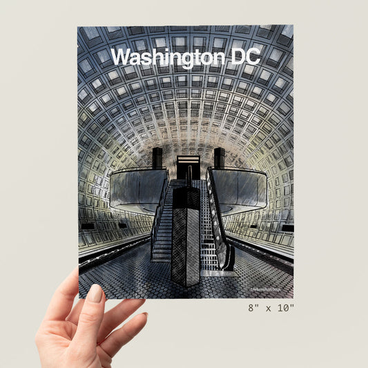 a hand holding up a picture of a subway station