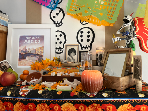 Dia de los muertos altar with flowers, candles and pictures