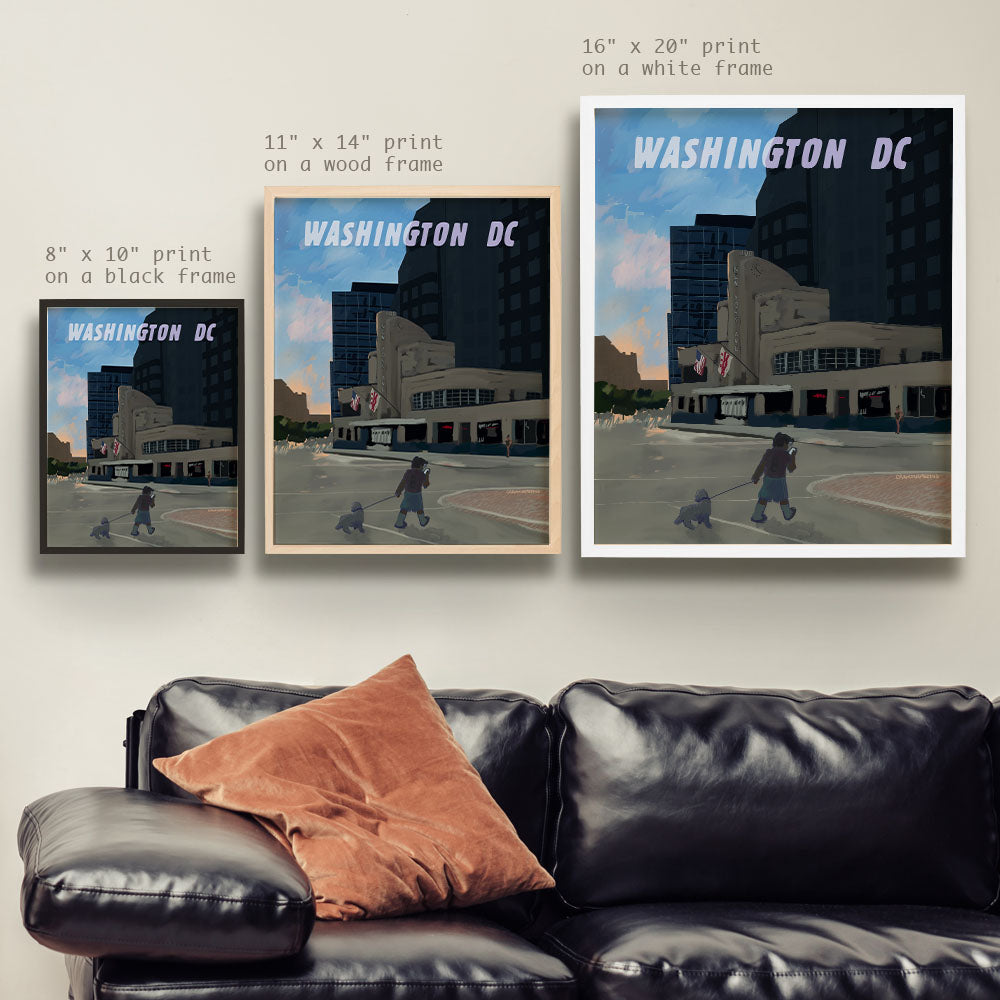 a living room with a couch and two posters on the wall