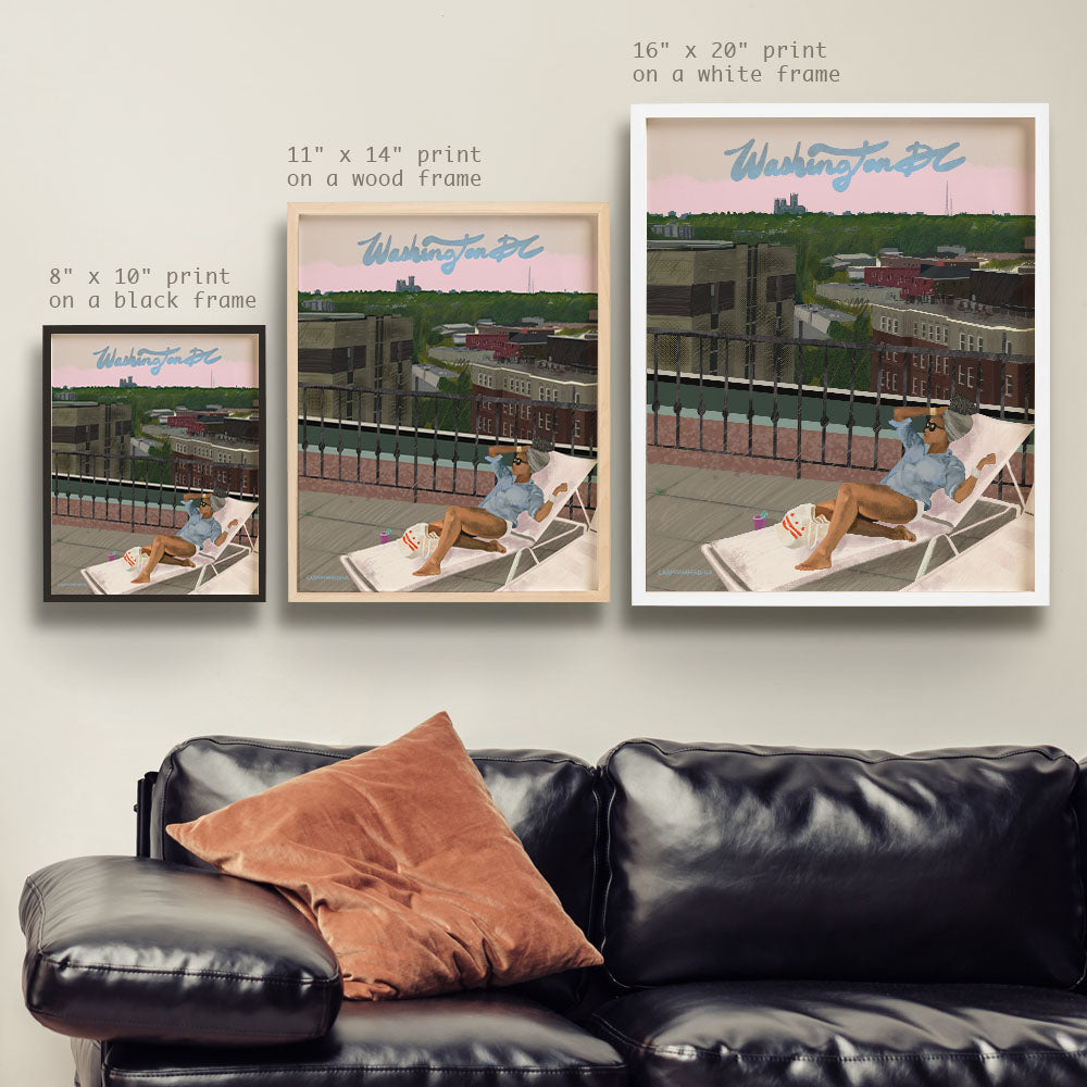 a couch with two pictures hanging on the wall