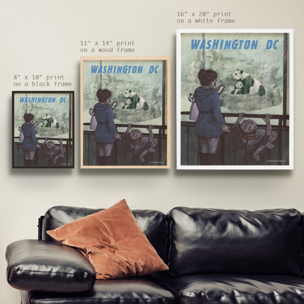 a living room with a black leather couch and two posters on the wall