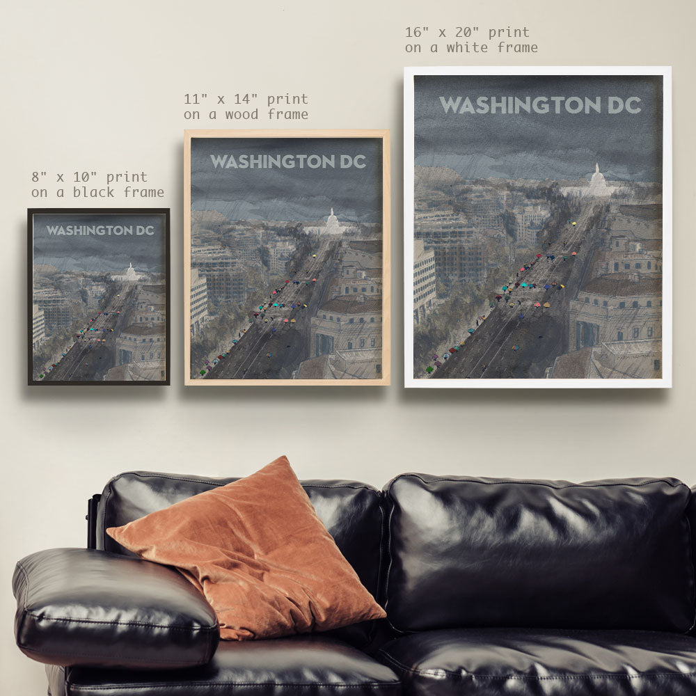 a living room with a black leather couch and two posters on the wall