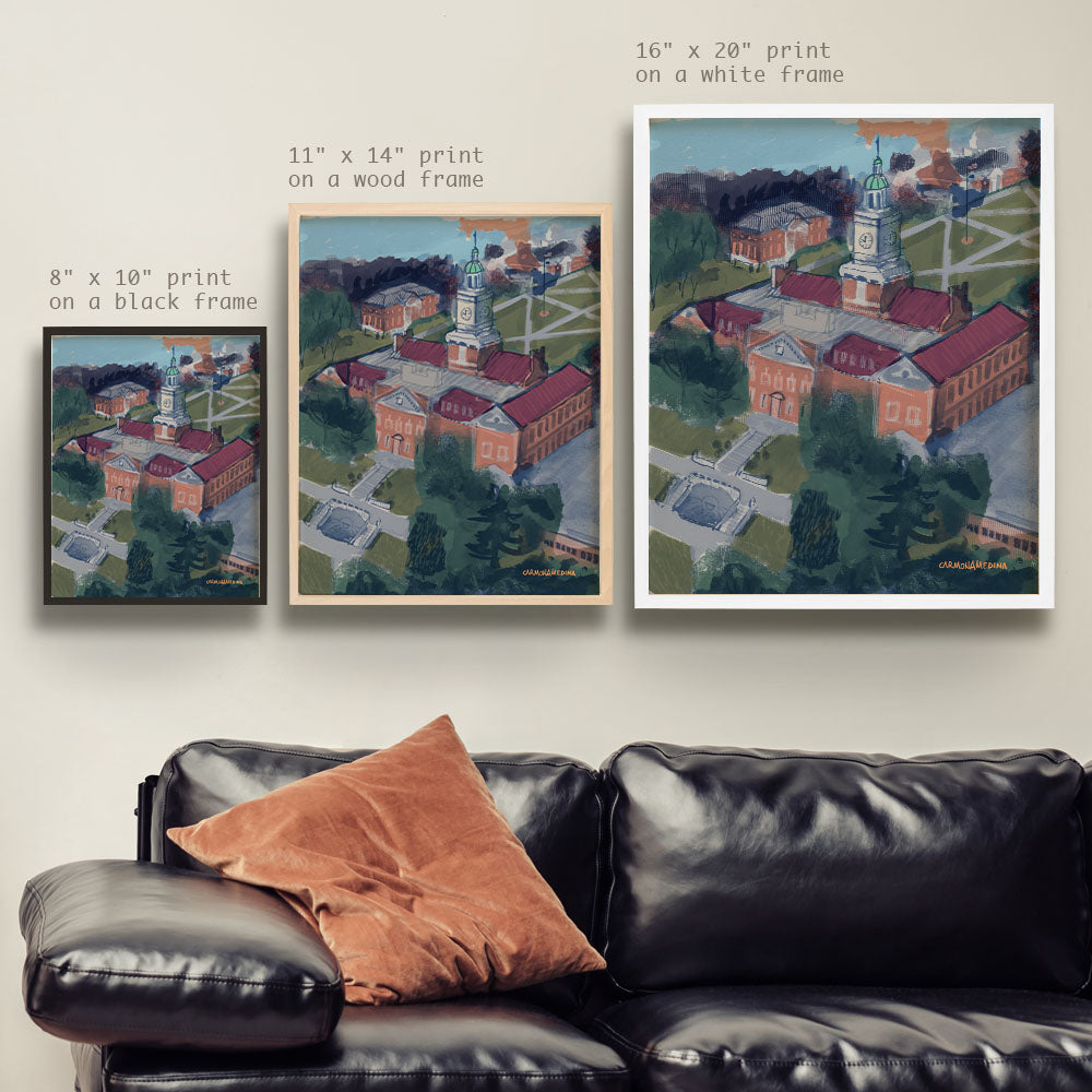 a living room with a couch and two pictures on the wall