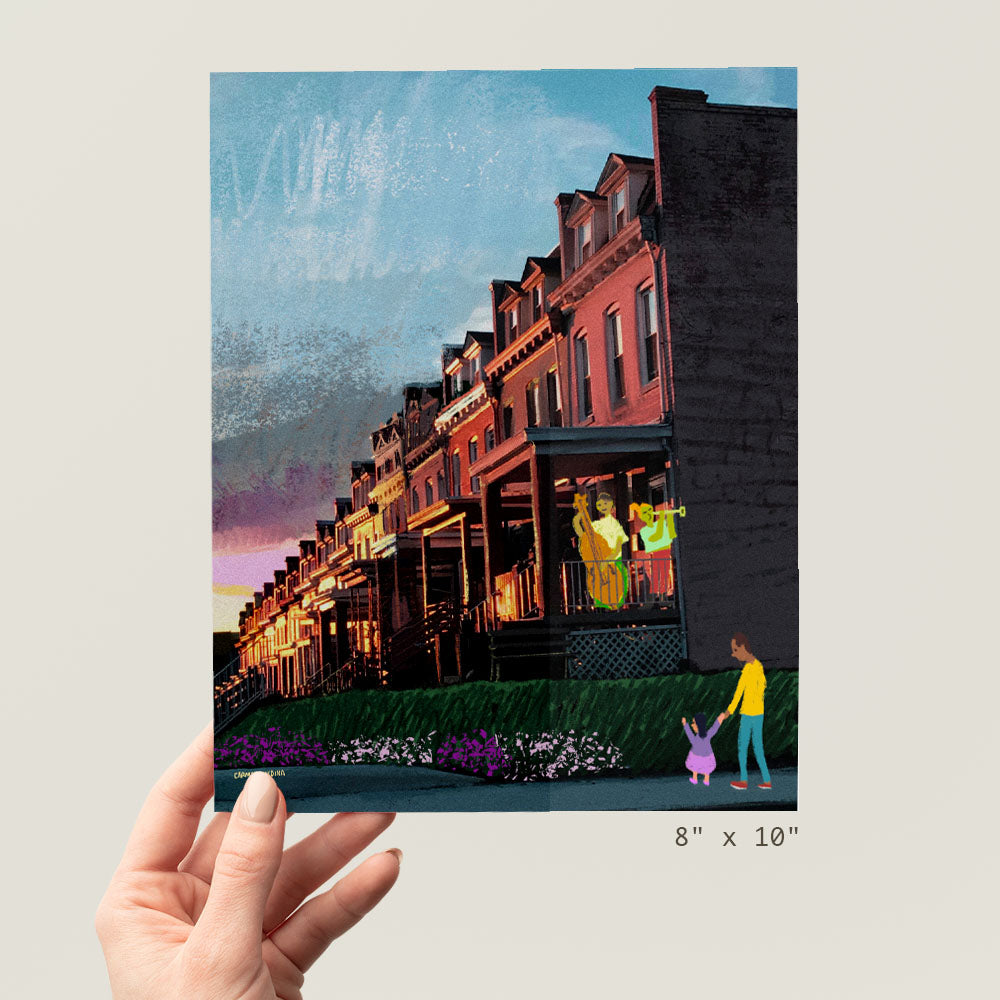 a person holding up a picture of a row of houses