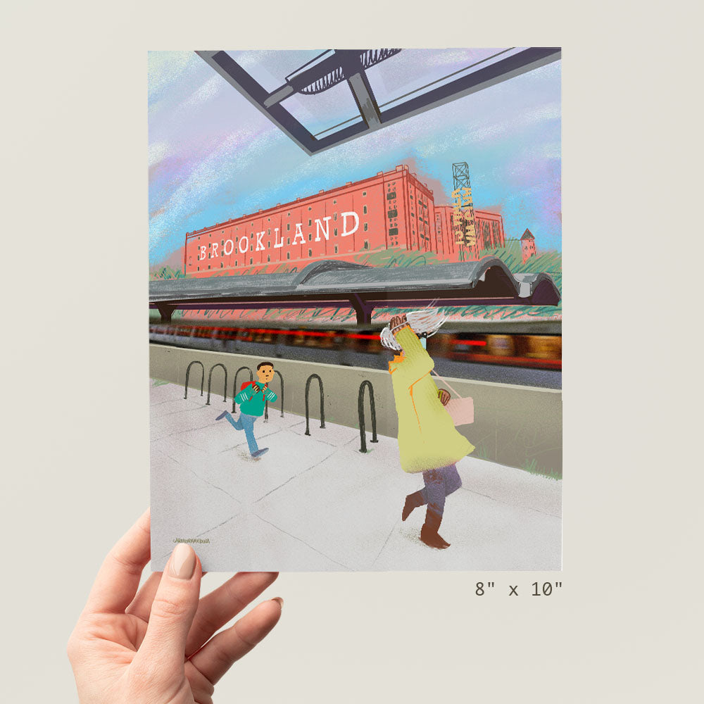 a person holding up a picture of a train station