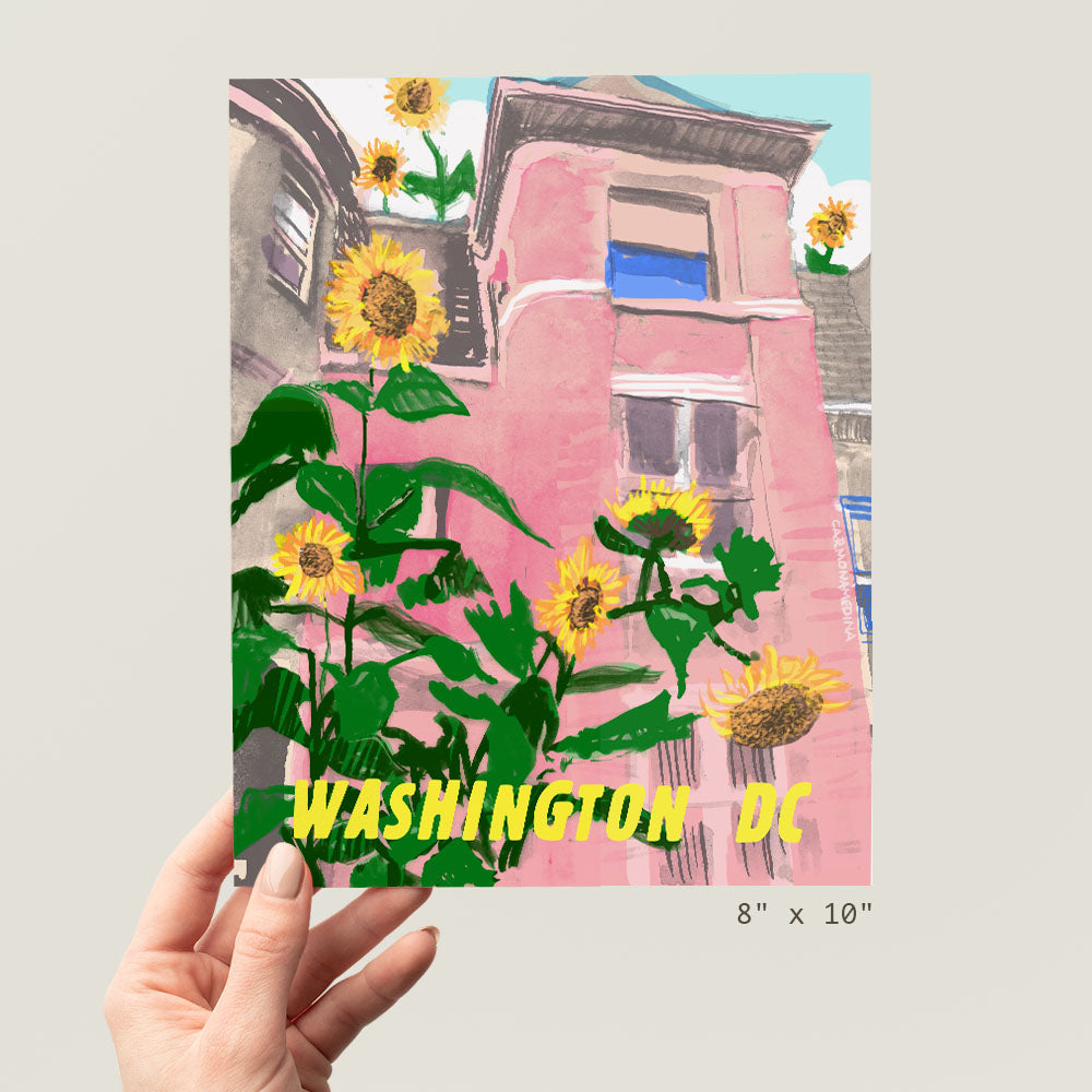 a hand holding up a card with a picture of sunflowers in front of