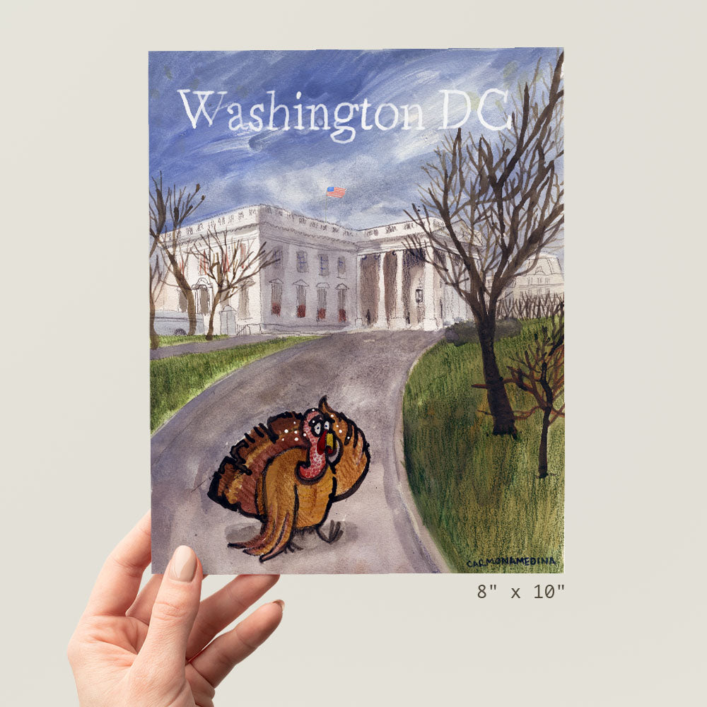 a person holding up a book about washington dc