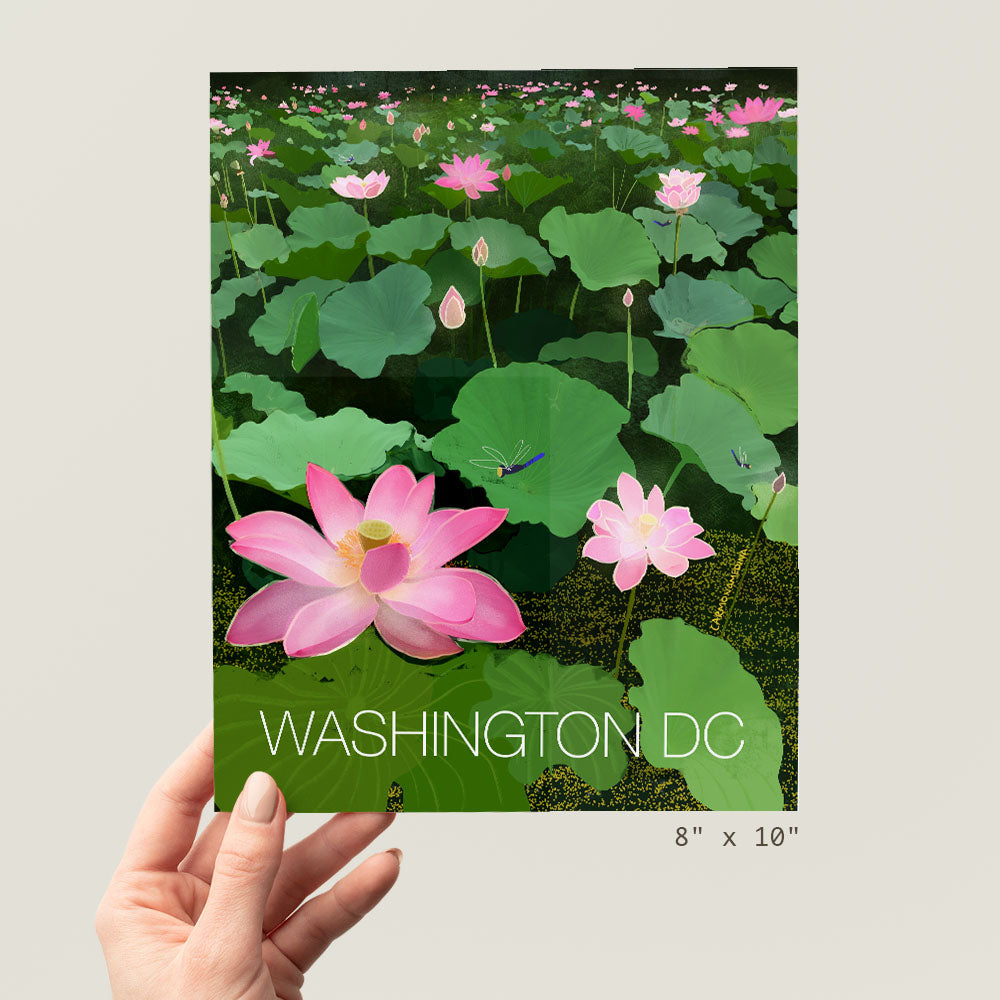 a person holding up a card with a picture of a pink flower